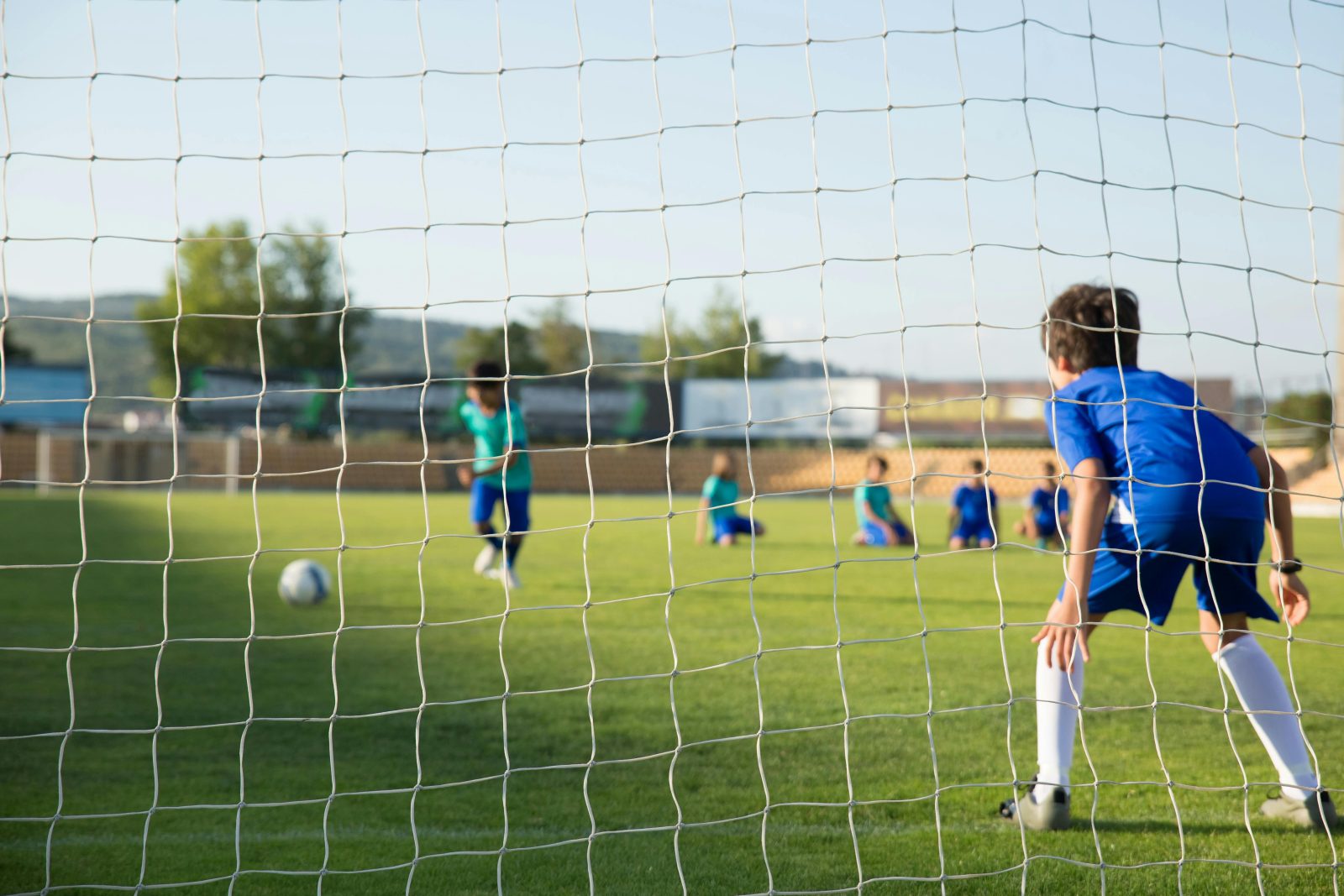 Fußballcamp – Kinder spielen auf dem Platz